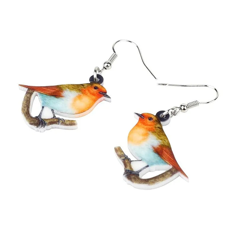 Pair of blue and white acrylic pendant earrings featuring a printed titmouse bird and snake design on geometric shapes.