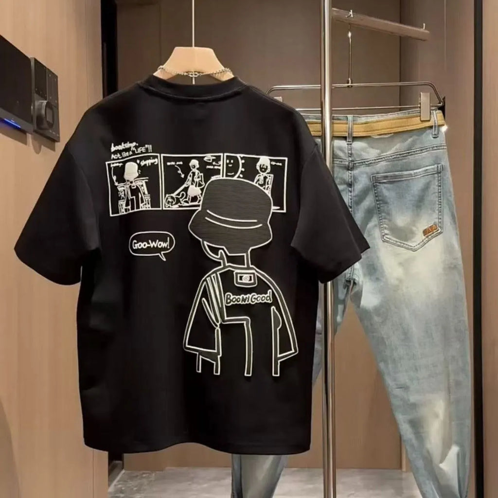 Man wearing a black slim fit pure cotton t-shirt with a simple cartoon print design on the front.