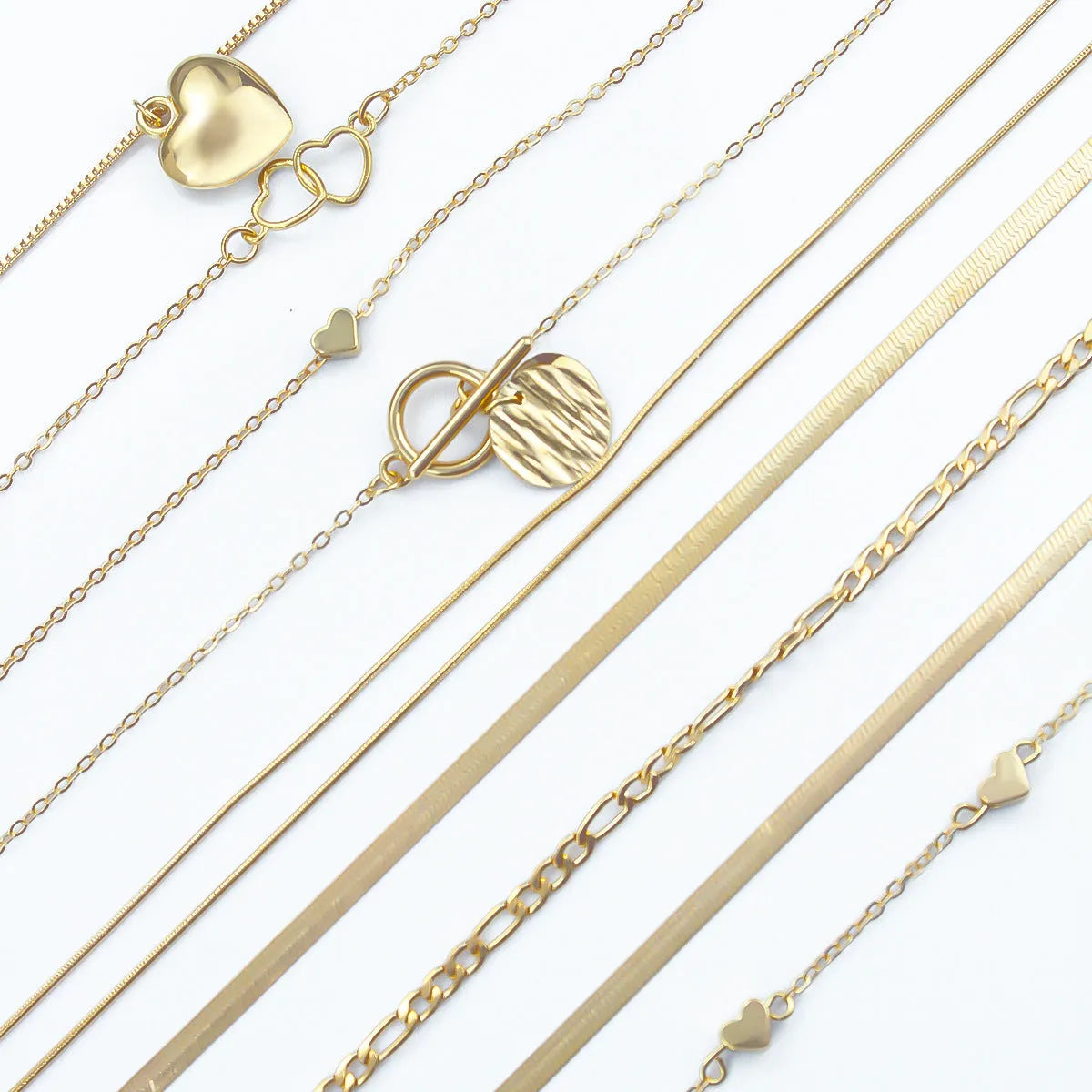 Set of ten gold women's fashion necklaces with snake bone chains and adjustable length on a white background.