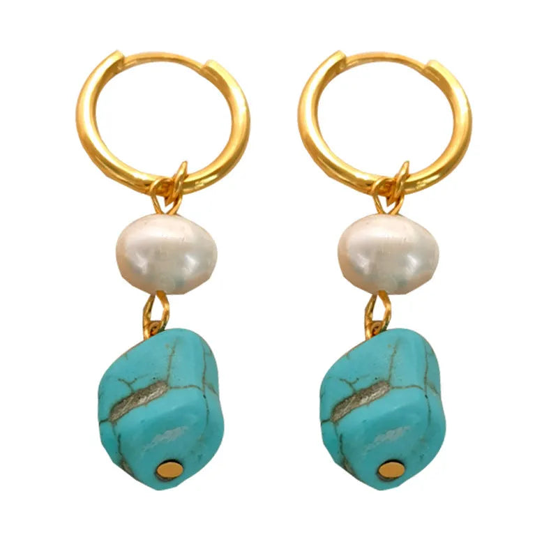 A pair of geometric clip-on earrings made of copper with turquoise and cultured pearls.