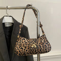 Women's casual PU leather handbag with sandwich pockets in brown colour showing 27cm length