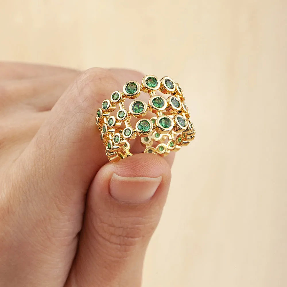 Copper ring with 18K gold plating and green zircon stones in exaggerated wide-band design