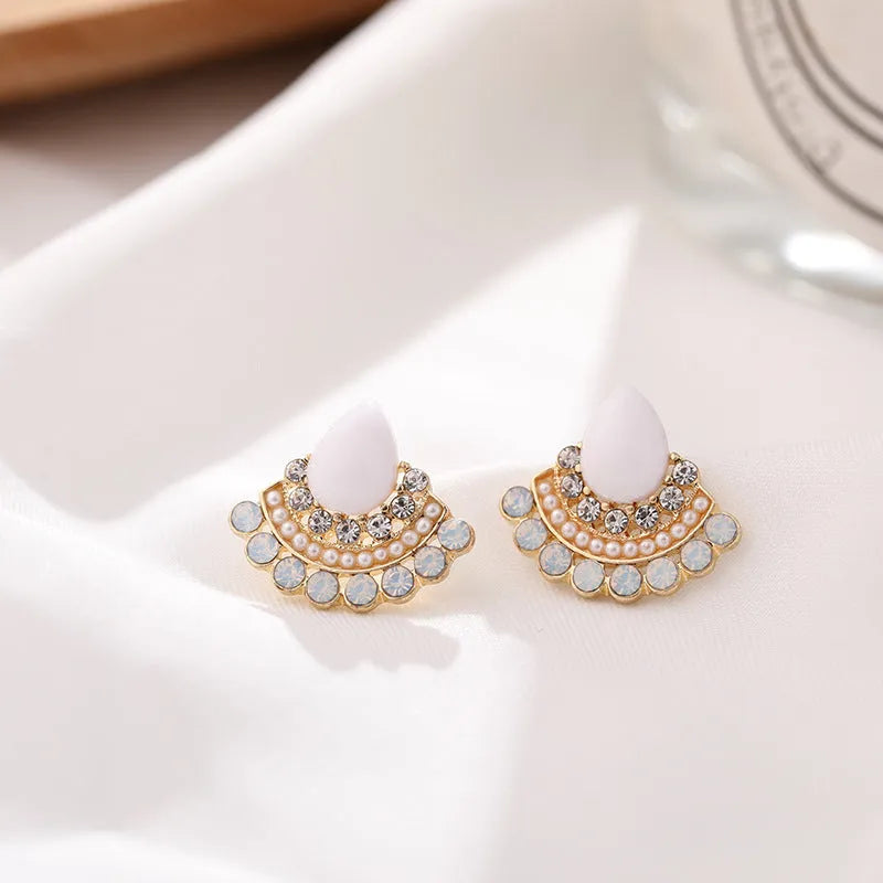 Women's retro silver-colour fan-shaped rhinestone earrings on a white background.