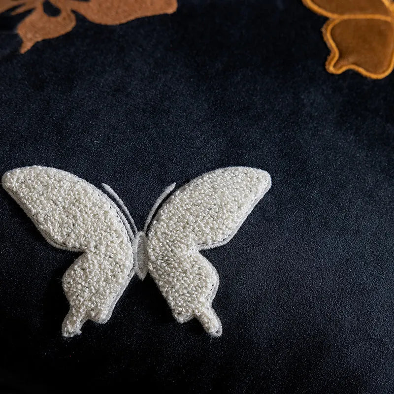 Square beige cushion with embroidered black butterfly pattern in Chinese style.