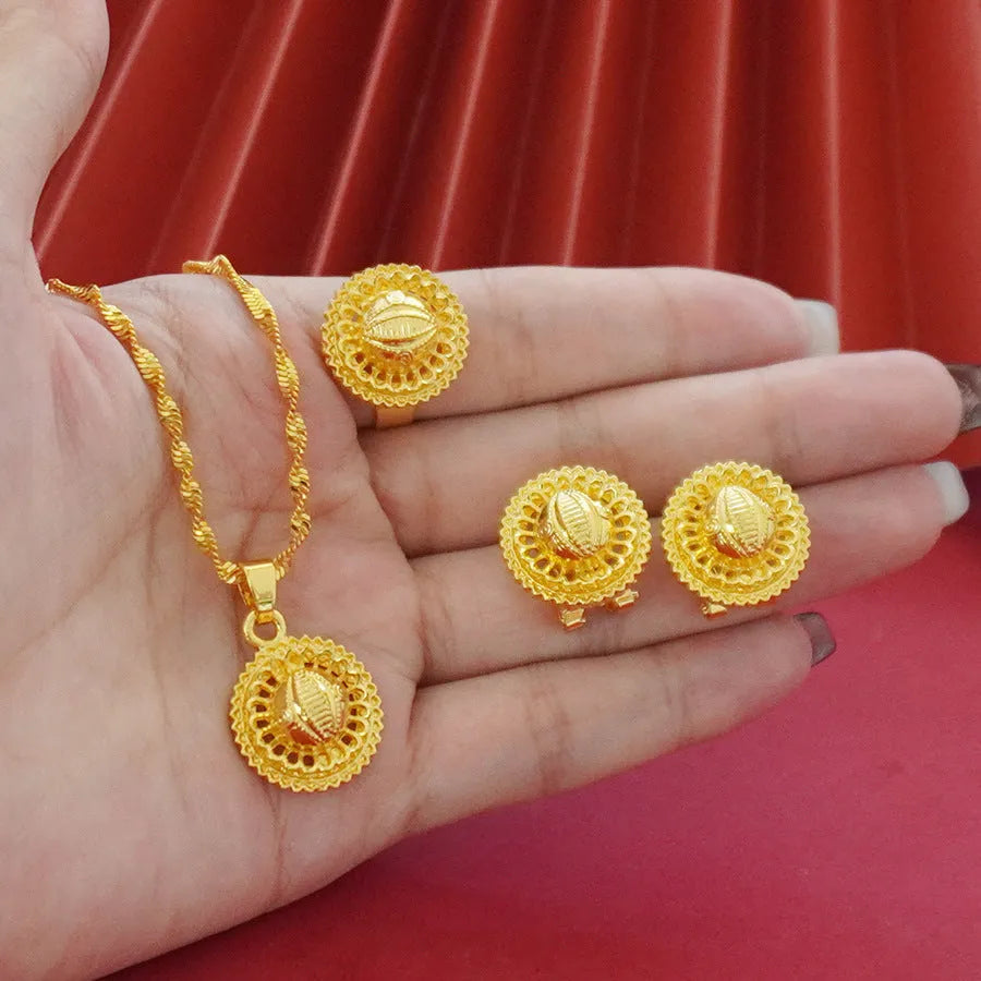 Gold-plated three-piece jewellery set with Middle Eastern flower design, showing necklace, pendant earrings, and ring.