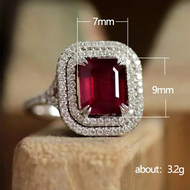 Geometric square red copper ring with a central rhinestone, shown from above.