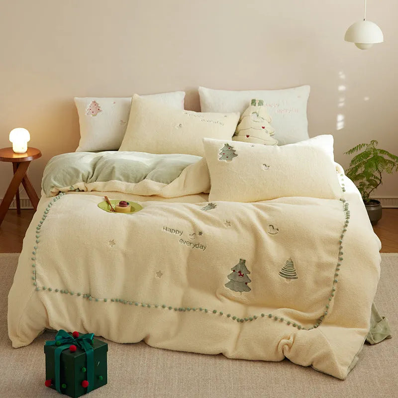 Milk fibre four-piece bedding set with green Christmas tree pattern on a double bed.