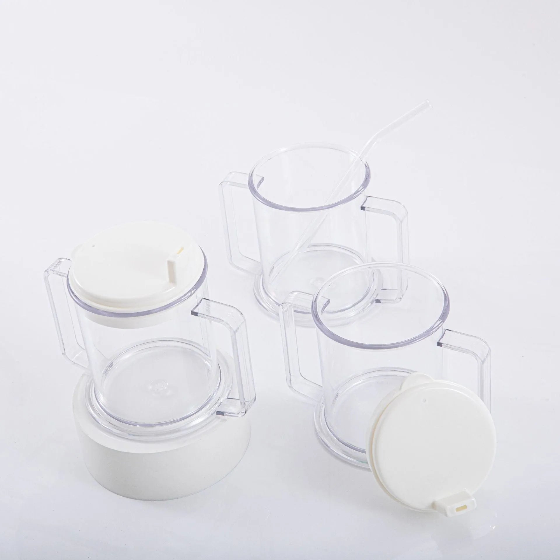 Transparent spill-proof plastic drinking cup on a plain background