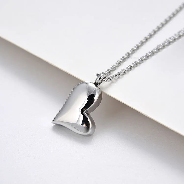 Silver curved peach heart stainless steel pendant necklace on adjustable length chain