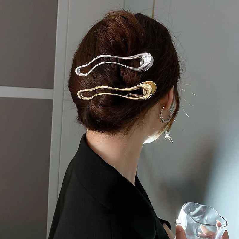 Gold and silver zinc alloy hair barrettes showing arc, square, and triangle shapes on a plain background.