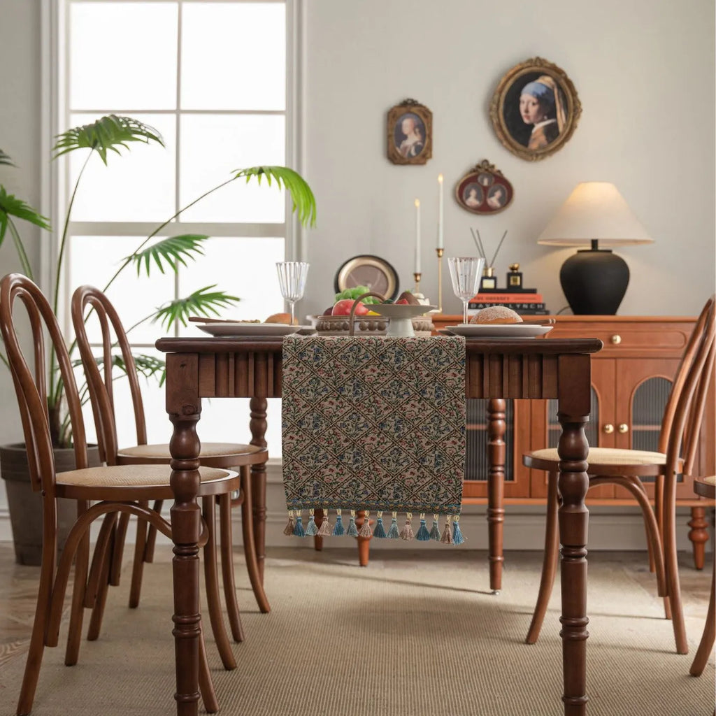 Dark blue Nordic stripe pattern jacquard table runner with tassel detail on a wooden table.