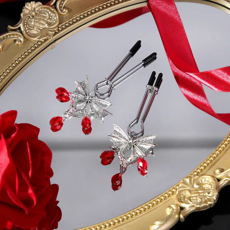 Silver alloy bat nipple clamp with adjustable tension and ruby detailing