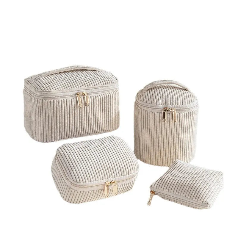 Set of four small pink cube-shaped flannelette makeup bags with zips, arranged together.
