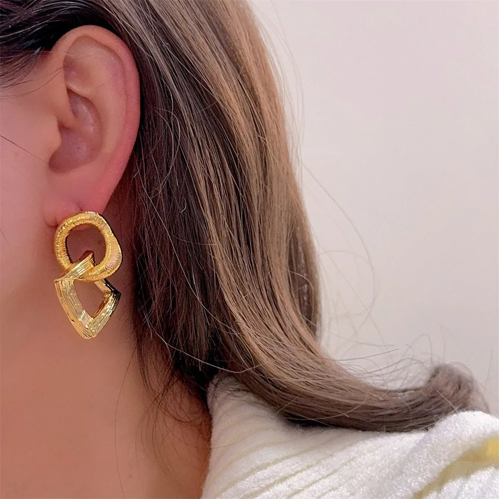 Geometric circle pendant earrings in gold or silver electroplated finish on copper, measuring 3.4cm height