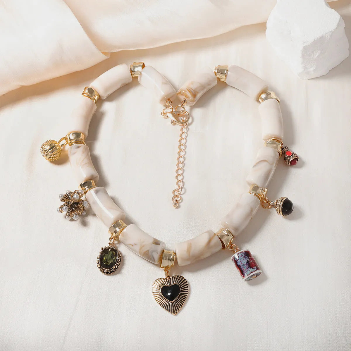 Heart-shaped resin pendant necklace with bamboo detail and adjustable chain