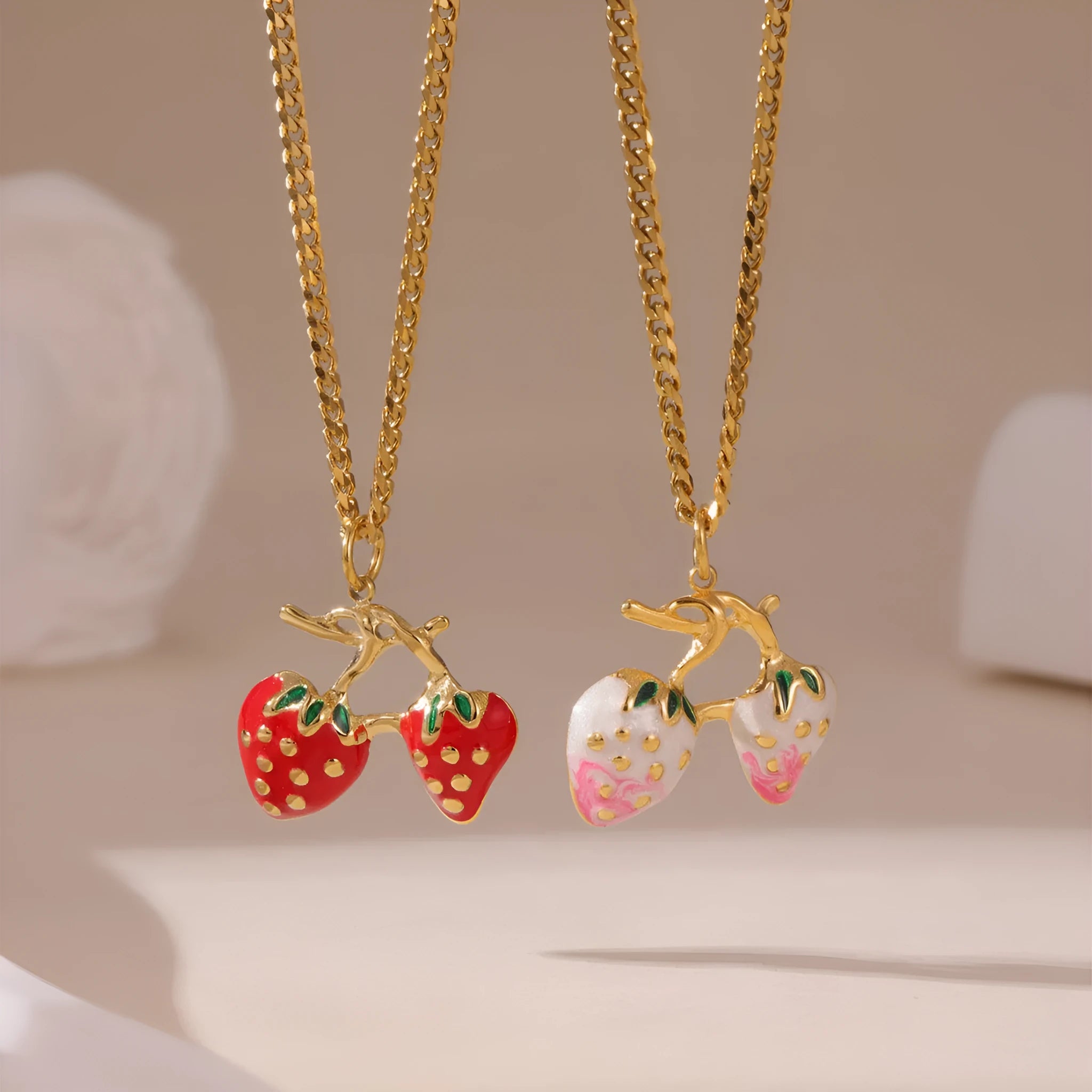 Close-up of a red strawberry pendant necklace on a silver alloy chain with adjustable clasp.
