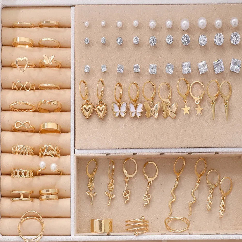 Assortment of 108 gold and yellow geometric alloy earrings with round pearl-like details on a white background.