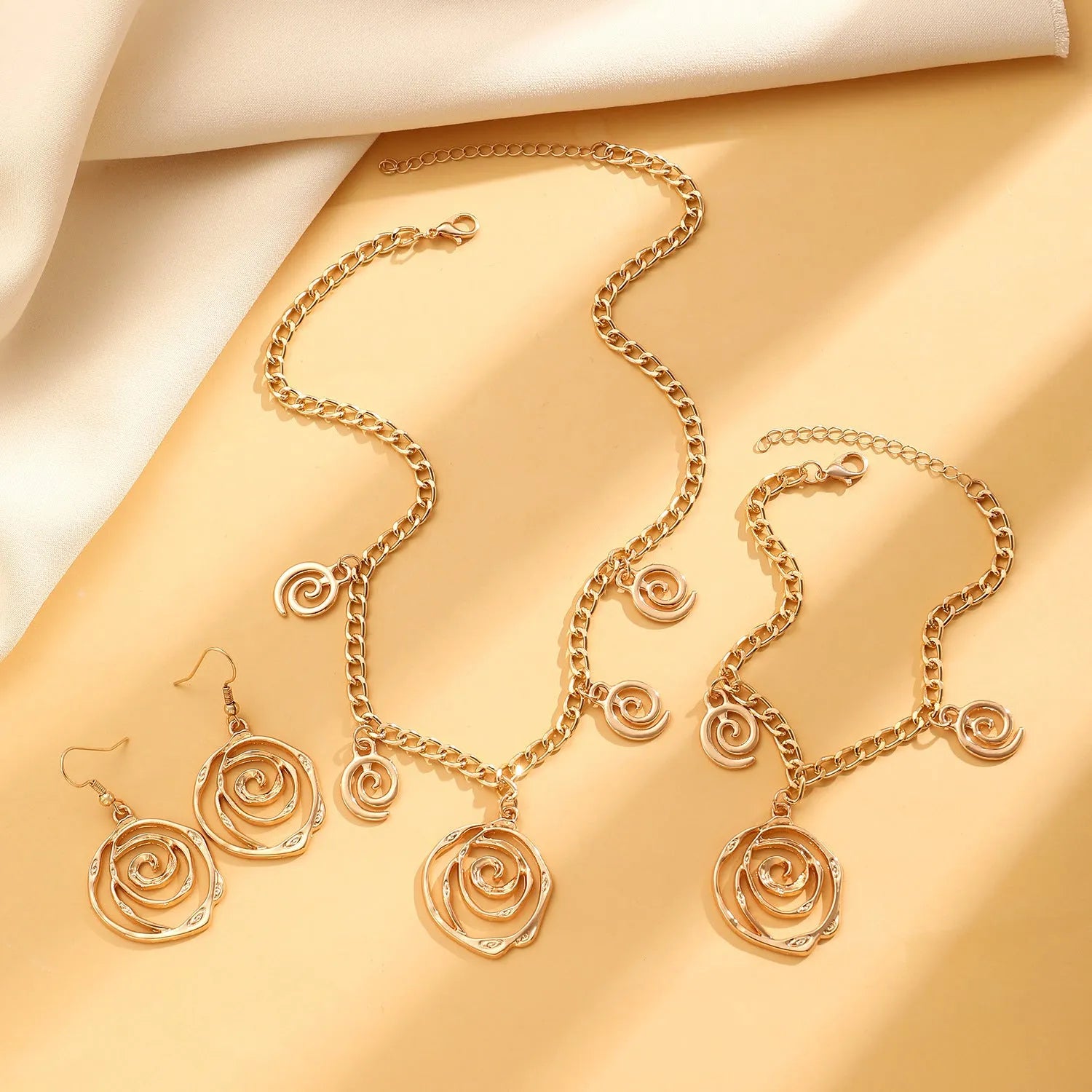 Spiral donut women's jewellery set showing necklace, bracelet, and earrings with geometry circle design