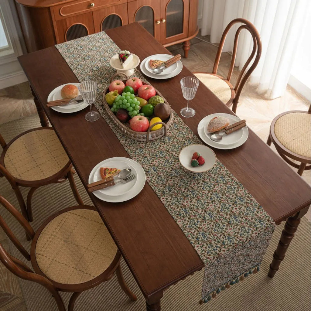 Dark blue Nordic stripe pattern jacquard table runner with tassel detail on a wooden table.