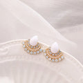 A pair of women's retro fan-shaped silver earrings with geometric rhinestone and needle opal decorative details.