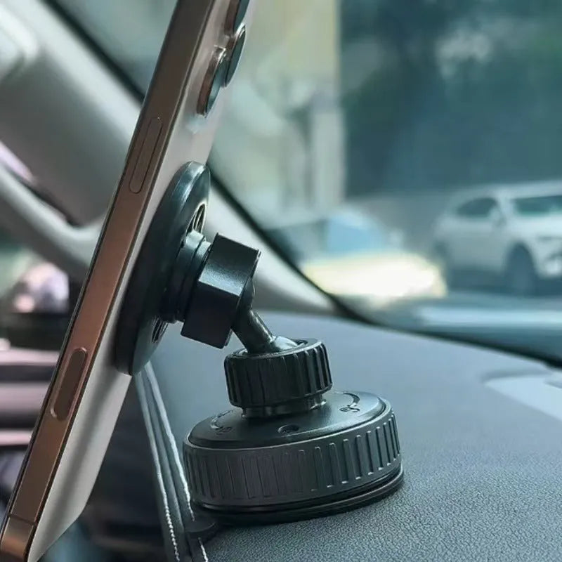 Black magnetic phone holder with 360-degree rotation and vacuum base on car dashboard