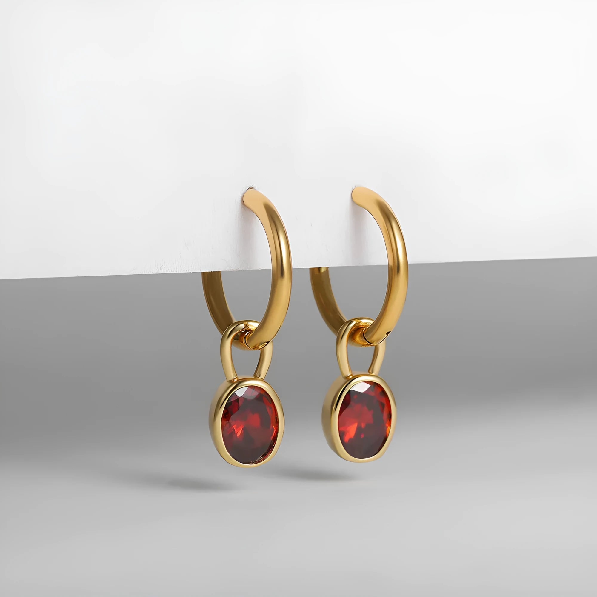 Women's oval zircon clip earrings in army green with polished copper setting on a white background.