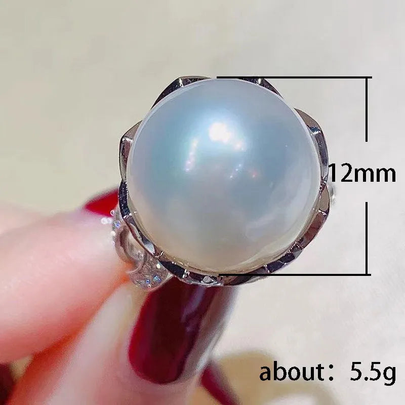 Copper female baroque pearl receptacle ring with inlaid zircon stones in white gold colour on white background