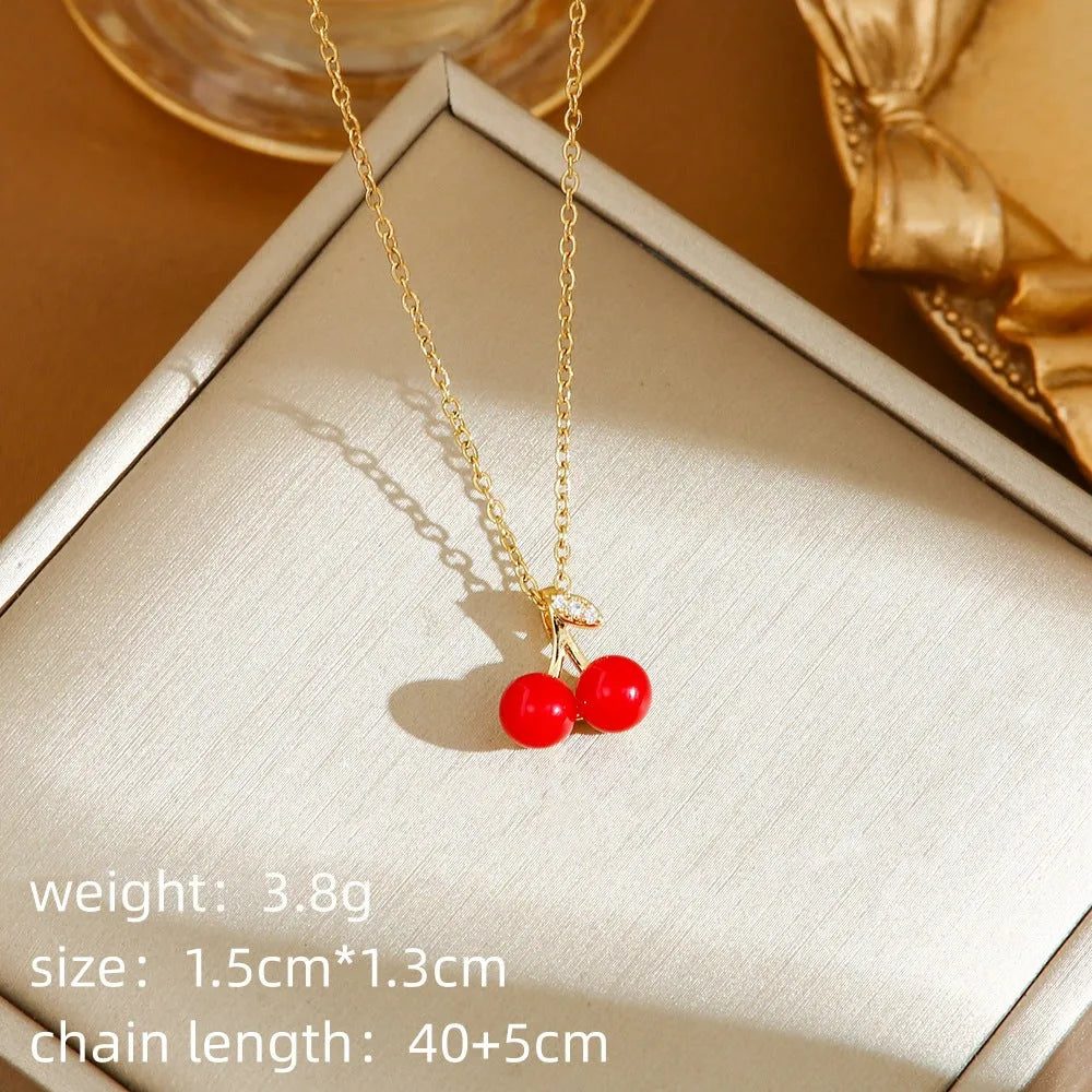 Delicate red indie cherry and strawberry pendant on a titanium steel O-ring necklace chain.
