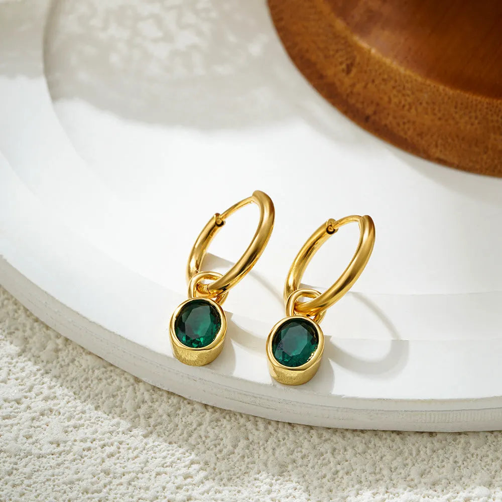 Women's oval zircon clip earrings in army green with polished copper setting on a white background.