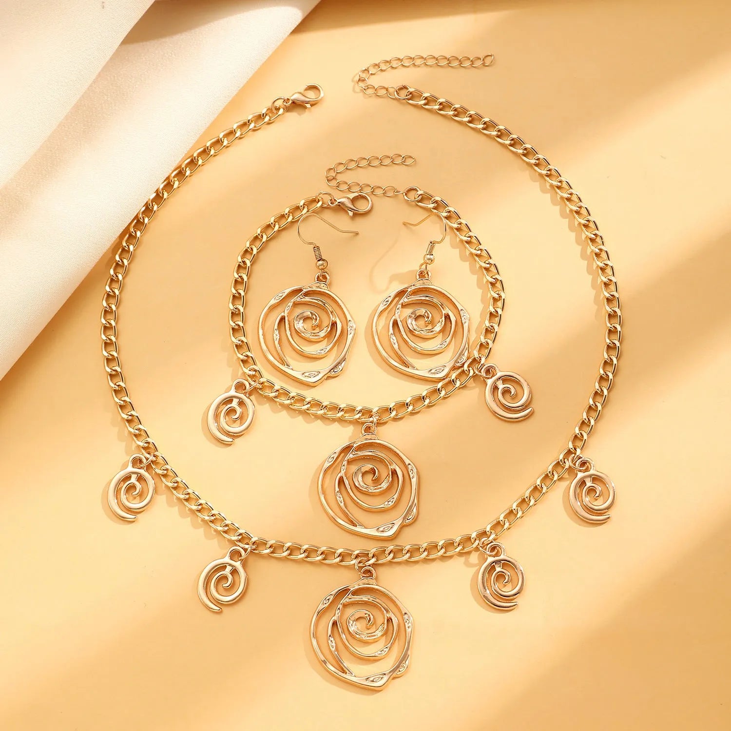 Spiral donut women's jewellery set showing necklace, bracelet, and earrings with geometry circle design