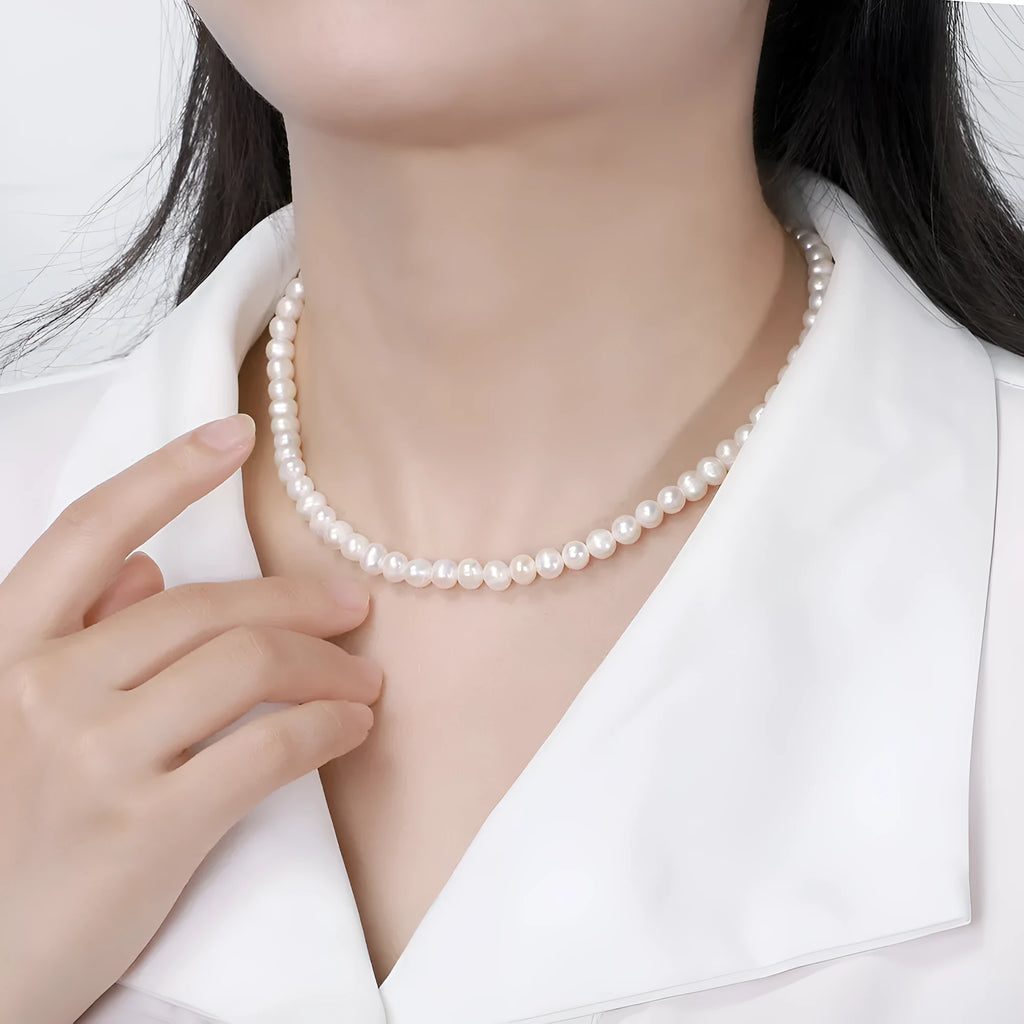 Women's adjustable sterling silver necklace with natural freshwater pearls.