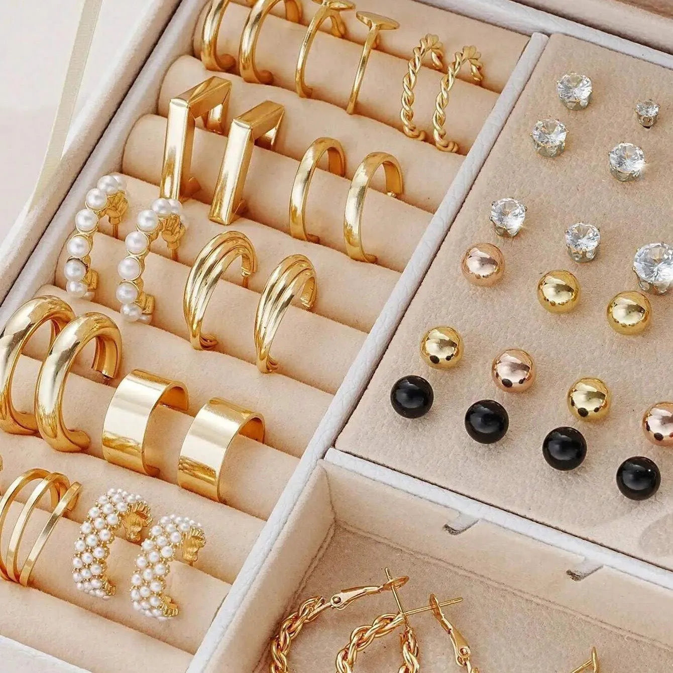 Assortment of 108 gold and yellow geometric alloy earrings with round pearl-like details on a white background.