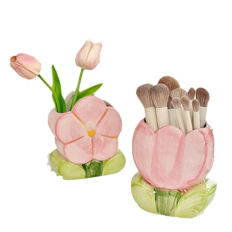 Ceramic floral pen holder box in pink tulip design on a desk.