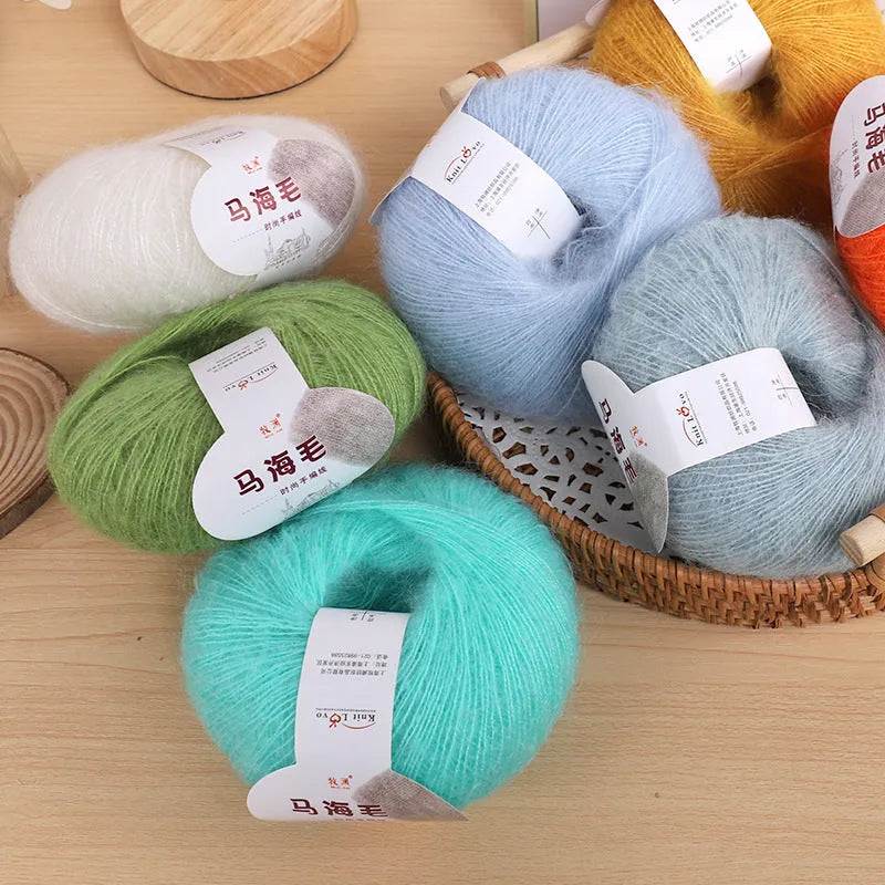 A 200g ball of mohair Inverness thread in a chosen colour, next to a measuring tape showing 180cm for the finished scarf length.