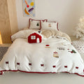 Cartoon winter Christmas themed bedding four-piece set including duvet cover, bed sheet, and two pillowcases made from polyester.