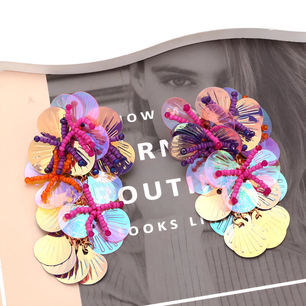Close-up of handmade exaggerated flower and leaf bead earrings in a colourful colour option.
