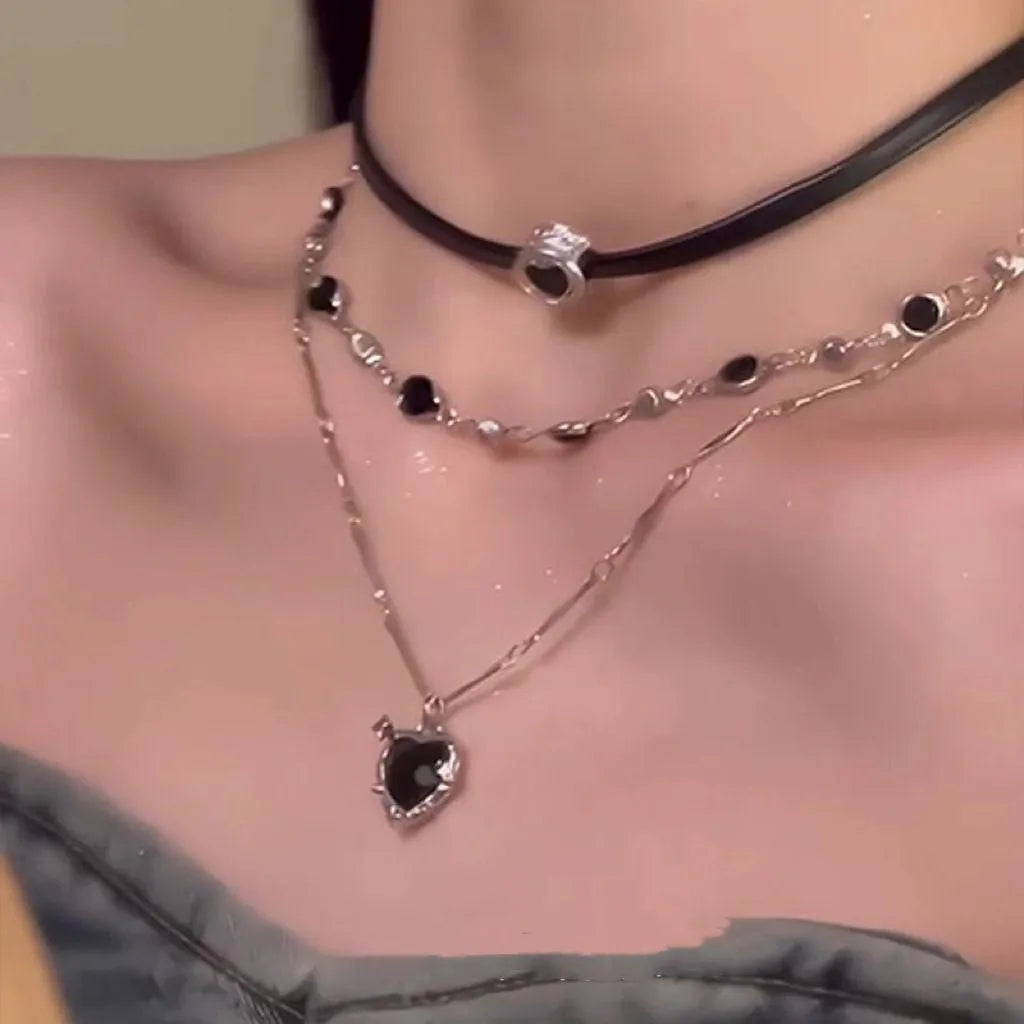Women's multi-layer twin necklace with leather heart pendant on adjustable alloy chain.