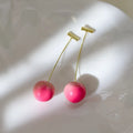 A pair of peach-shaped stud earrings in coloured acrylic, shown in small and large sizes.