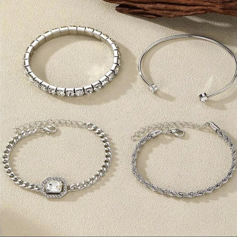 Set of four women's alloy bracelets with geometric square diamond charms and metal chains in gold or silver.