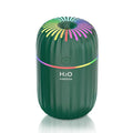 Green mini car USB aromatherapy humidifier on a desk with USB cable.