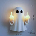 White plastic ghost statue night lamp for Halloween decoration on a dark surface.