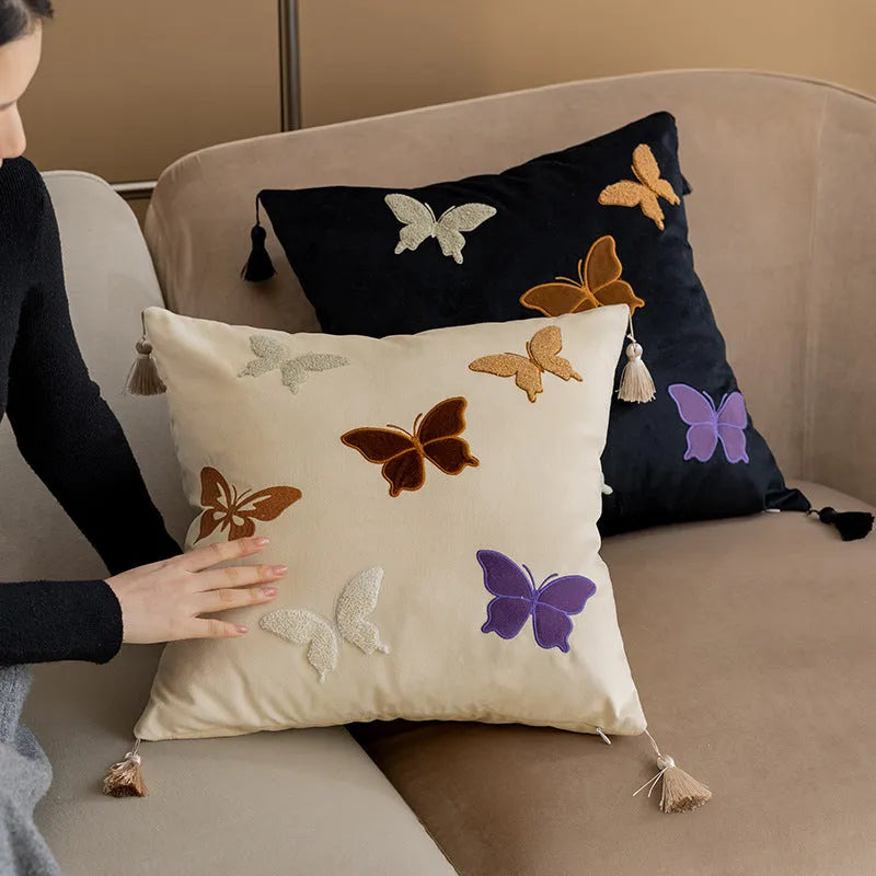 Square beige cushion with embroidered black butterfly pattern in Chinese style.