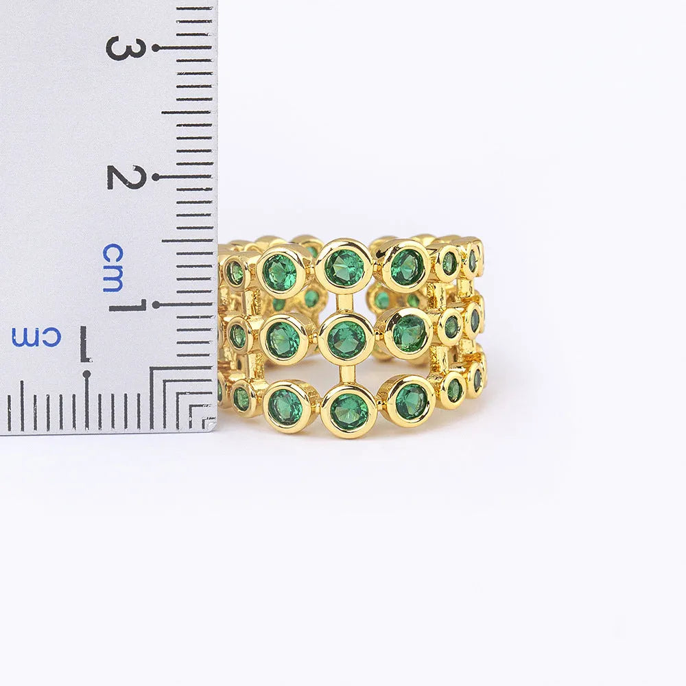Copper ring with 18K gold plating and green zircon stones in exaggerated wide-band design
