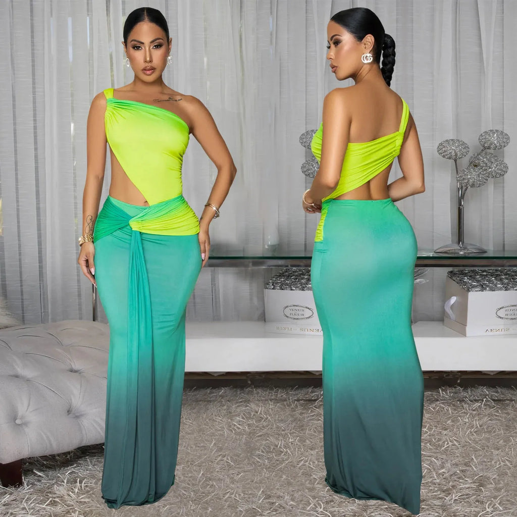 A woman wearing a long, gradient-coloured dress with a cross-shoulder design and high waist.