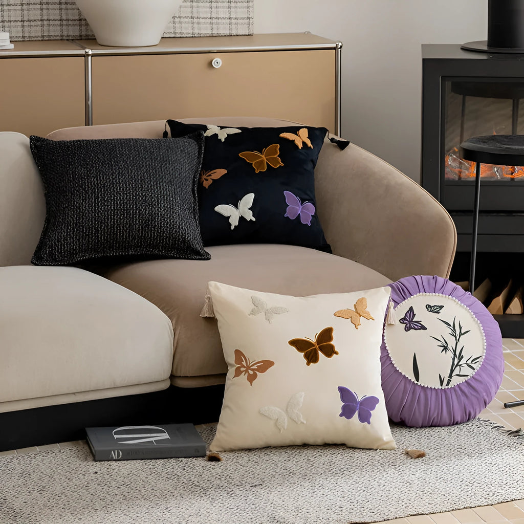 Square beige cushion with embroidered black butterfly pattern in Chinese style.
