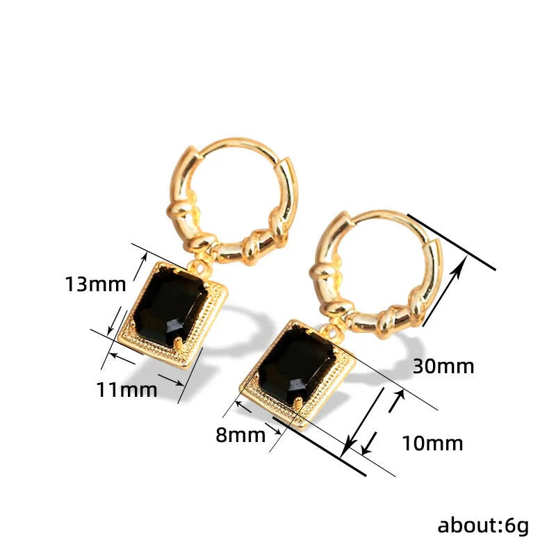 Close-up of women's geometric quadrilateral copper earrings with a black zircon stone and butterfly back.