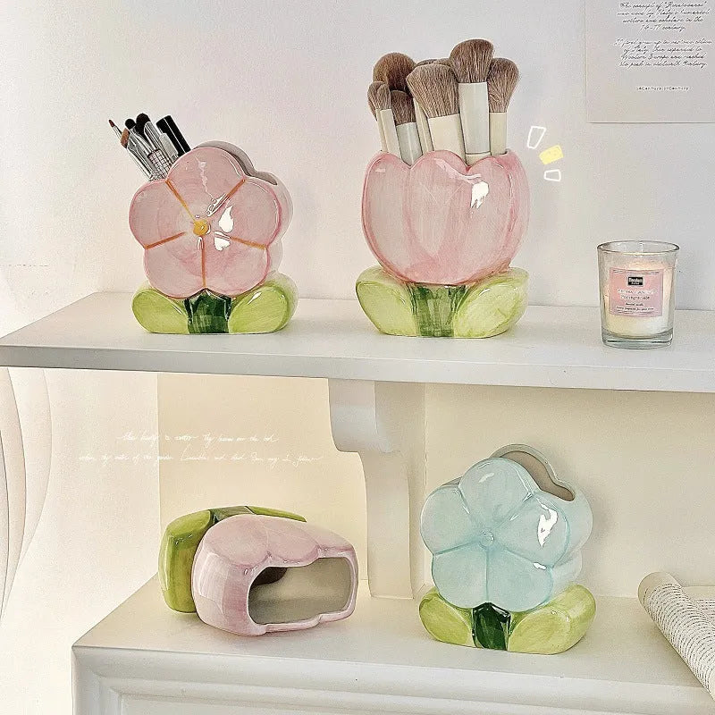 Ceramic floral pen holder box in pink tulip design on a desk.