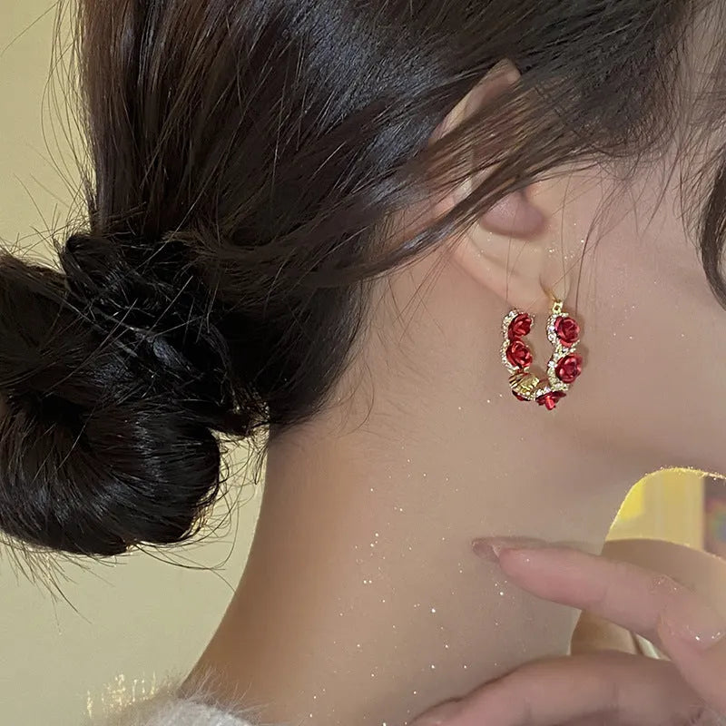 Red flower-shaped alloy ear clip earrings with rose design elements for women