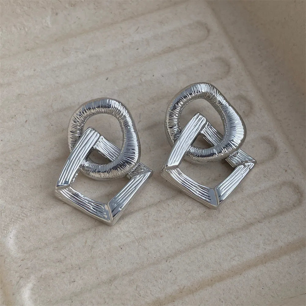 Geometric circle pendant earrings in gold or silver electroplated finish on copper, measuring 3.4cm height