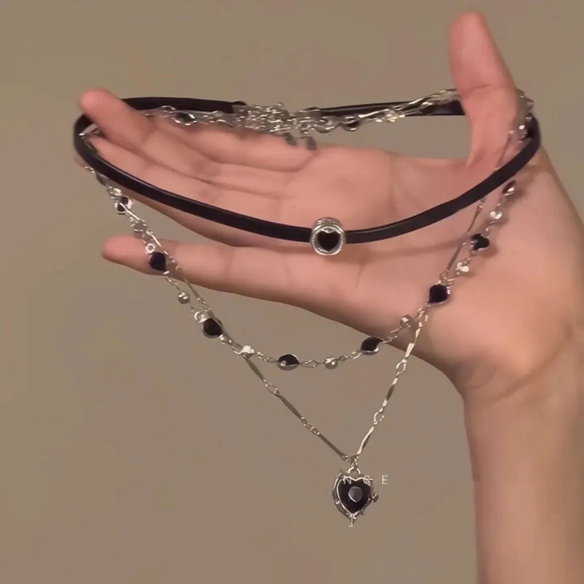 Women's multi-layer heart necklace with adjustable chain, alloy pendant, and artificial crystals.